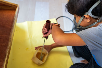 High angle view of woman sitting on sofa