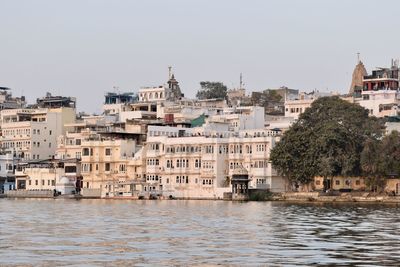 Buildings in city against clear sky