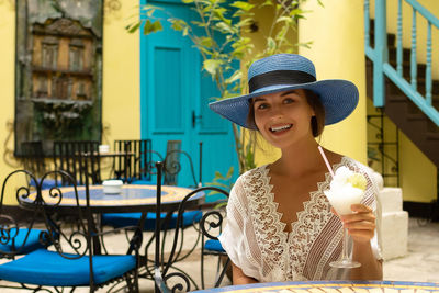 Portrait of woman drinking wine at restaurant