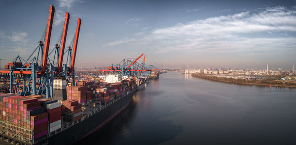 Panoramic view of commercial dock against sky