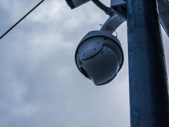 Low angle view of electric lamp against sky