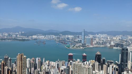 Panoramic view of sea and modern buildings against sky