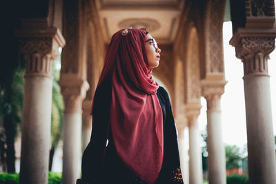 Midsection of woman standing in front of building