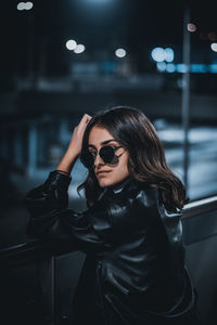 Woman wearing sunglasses at night