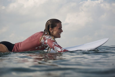 Portrait of woman in sea against sky