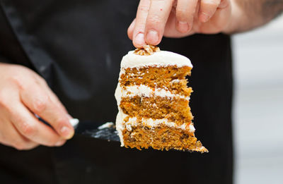 Carrot cake with cream cheese frosting and little carrots on top