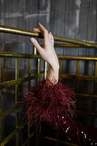 Cropped image of woman standing by fence