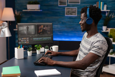 Smiling professional using computer at office