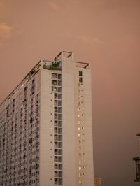 Low angle view of building against sky during sunset