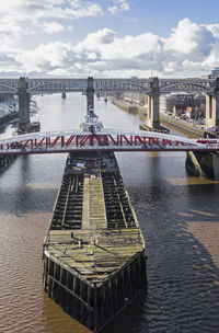 View of bridge over river against cloudy sky