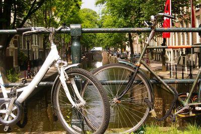Bicycle by railing against canal