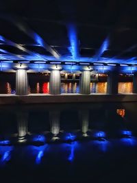 Reflection of illuminated lights in blue water