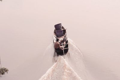 Man sitting on boat in lake