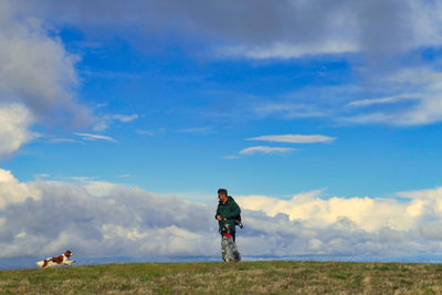 Man standing on field against sky