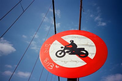 Low angle view of road sign against sky