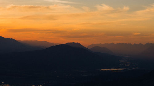 Scenic view of mountains against sky at sunset