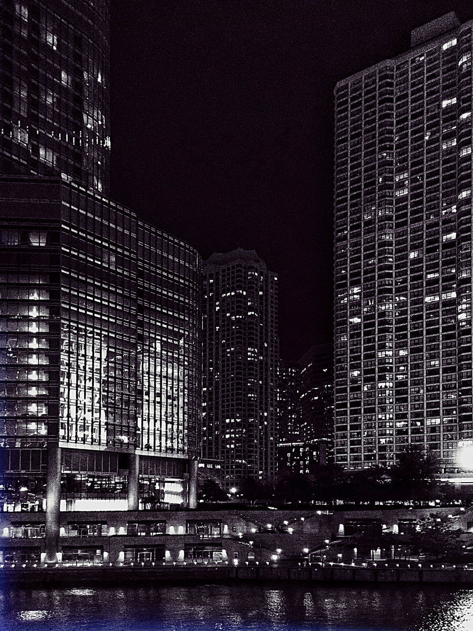 ILLUMINATED BUILDINGS AGAINST SKY AT NIGHT