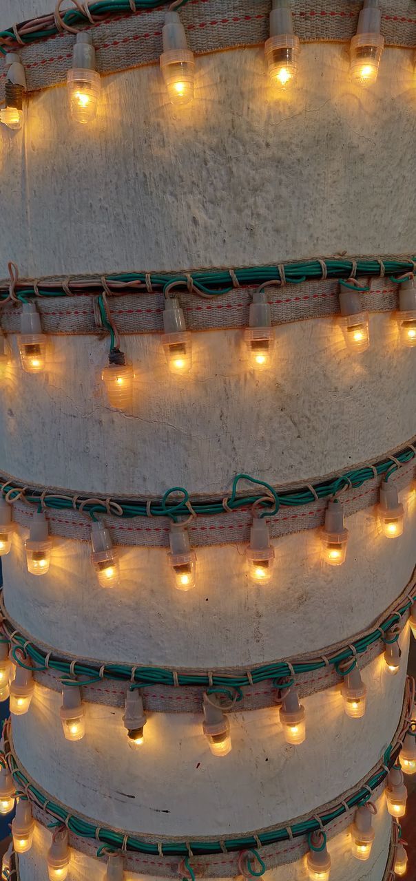 HIGH ANGLE VIEW OF ILLUMINATED LIGHT BULBS IN CEILING