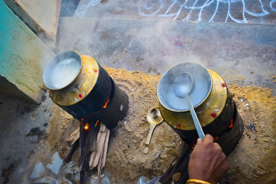 High angle view of person preparing food on barbecue grill
