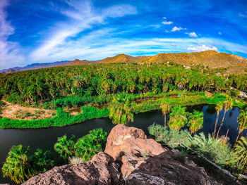 Scenic view of lake by mountain against sky