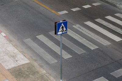 High angle view of road sign on street