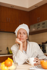 Portrait of woman preparing food at home