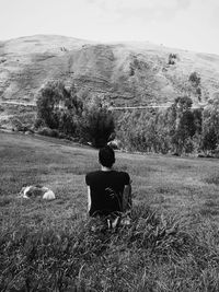 Rear view of a man sitting outdoors