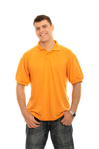 Portrait of young man standing against white background