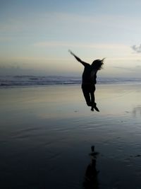 Full length of a man jumping on beach