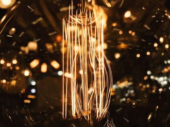 Close-up of illuminated light bulb at night