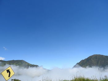 Scenic view of mountains against clear blue sky