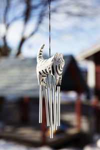 A wooden figure representing a cat used for a wind chime