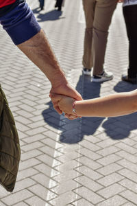 Low section of people walking on footpath