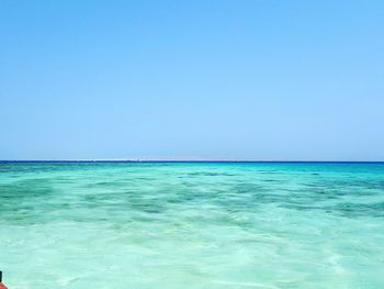 Scenic view of sea against clear blue sky
