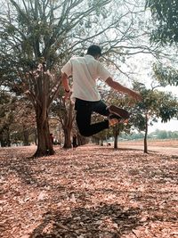 Man by tree on field