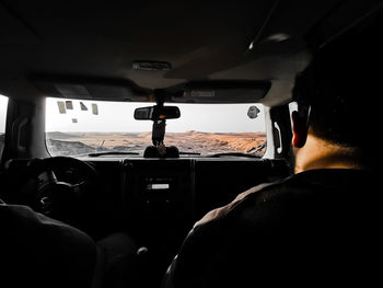 Rear view of man driving car