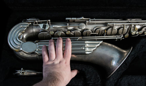 Cropped hand holding saxophone