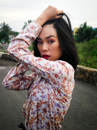 Portrait of young woman standing outdoors