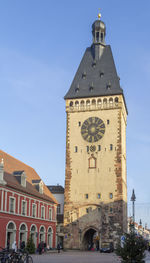 Clock tower of building against blue sky