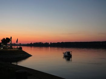 Scenic view of lake against romantic sky at sunset
