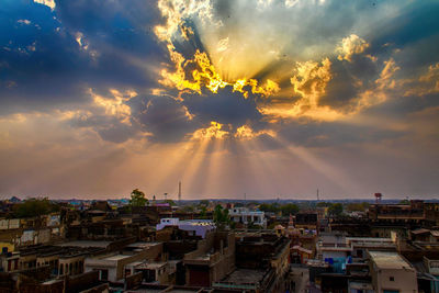 High angle shot of townscape against sky at sunset