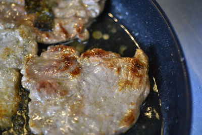 High angle view of meat in cooking pan