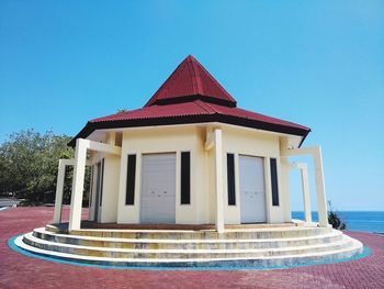 Low angle view of building against clear blue sky