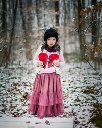 Portrait of a girl standing in forest