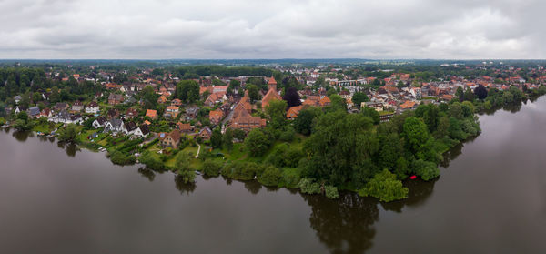 Aerial view of trees and buildings against sky