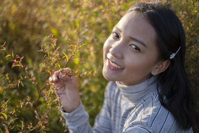 Portrait of smiling young woman outdoors