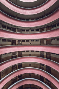 Creative architecture of cylindrical shaped residential building located in hong kong while a photographer takes photos