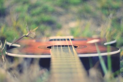 Close-up of guitar on field