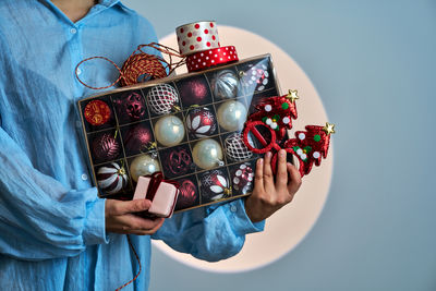 Midsection of woman holding christmas decoration
