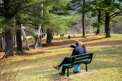 Rear view of couple sitting in park